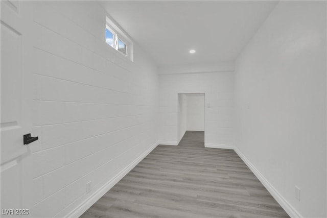 interior space featuring recessed lighting, baseboards, and wood finished floors