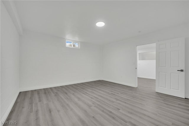 unfurnished room with baseboards and wood finished floors