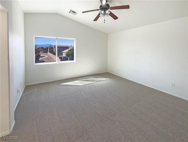 spare room with visible vents, lofted ceiling, carpet floors, and ceiling fan