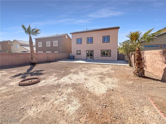 back of house featuring stucco siding, central air condition unit, a fenced backyard, and a patio area