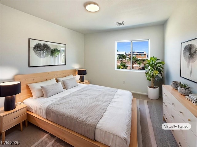 carpeted bedroom featuring visible vents