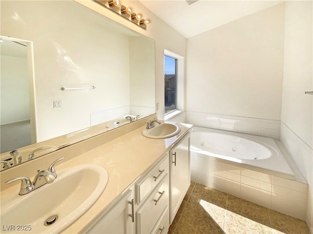 bathroom featuring double vanity, a whirlpool tub, tile patterned floors, and a sink