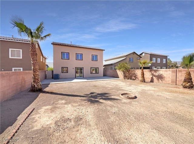 back of property featuring a fenced backyard, stucco siding, and a patio