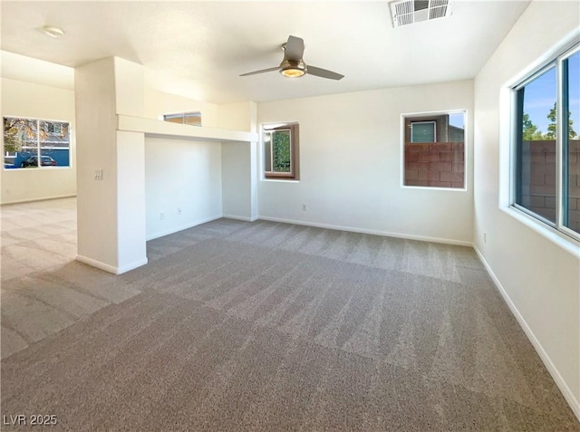 spare room with carpet flooring, baseboards, visible vents, and ceiling fan