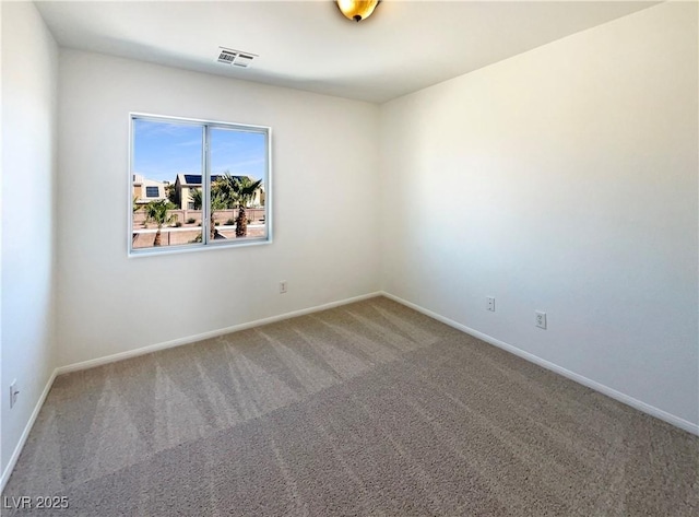 carpeted spare room with baseboards and visible vents