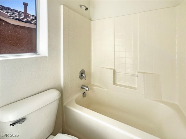 bathroom featuring  shower combination, toilet, a healthy amount of sunlight, and a textured wall