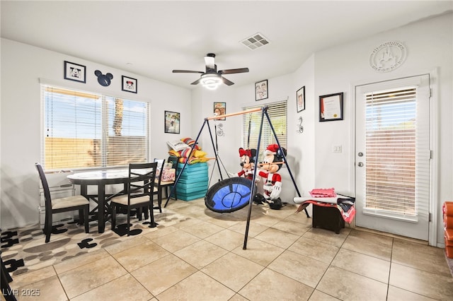 rec room featuring light tile patterned flooring, visible vents, and plenty of natural light