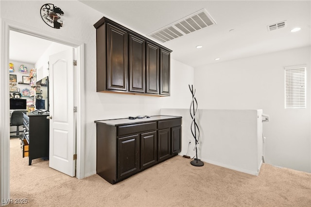 clothes washing area with recessed lighting, visible vents, and light colored carpet