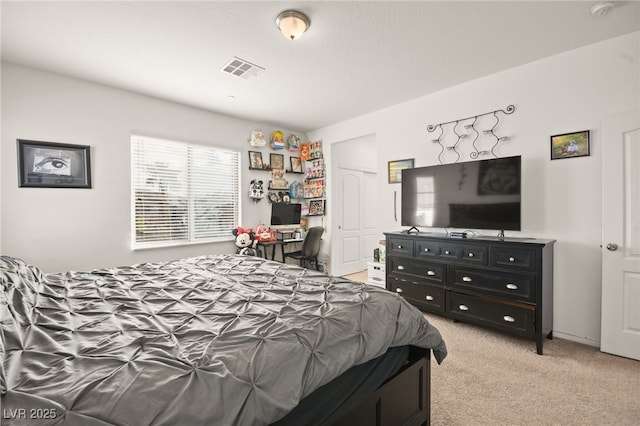 bedroom featuring visible vents and light colored carpet