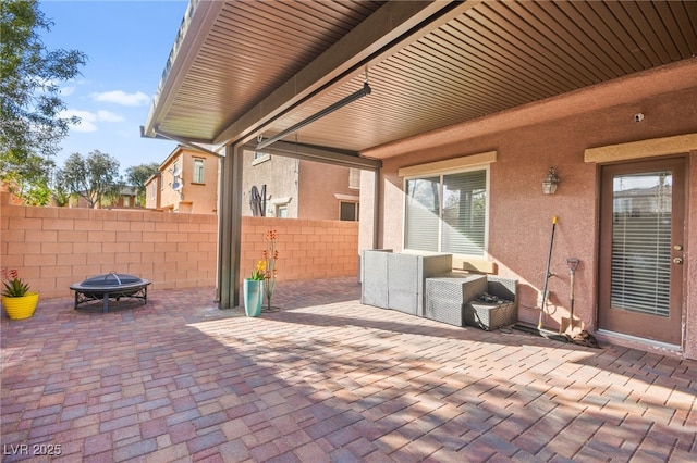 view of patio / terrace featuring a fire pit and fence