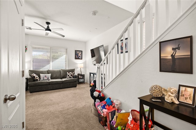 living area with a ceiling fan, stairway, carpet, and visible vents