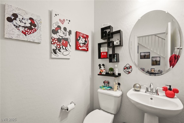 bathroom with toilet and a sink