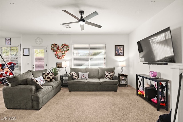 carpeted living area featuring a ceiling fan and visible vents