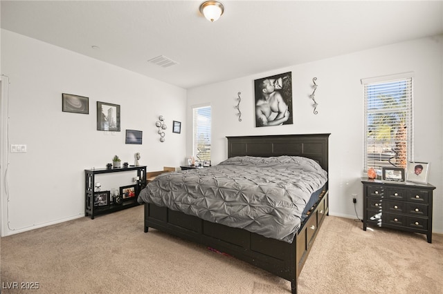 bedroom featuring visible vents, light colored carpet, and baseboards