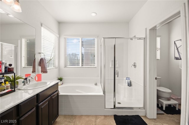 bathroom with plenty of natural light, vanity, a bath, and a shower stall