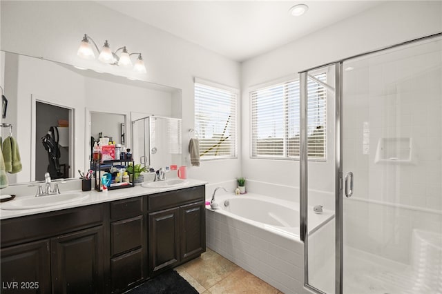 full bath featuring a sink, a stall shower, double vanity, and a bath