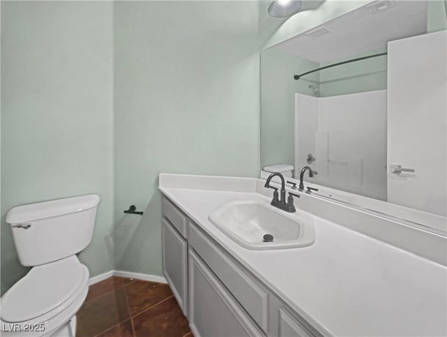 bathroom with vanity, visible vents, baseboards, tile patterned flooring, and toilet