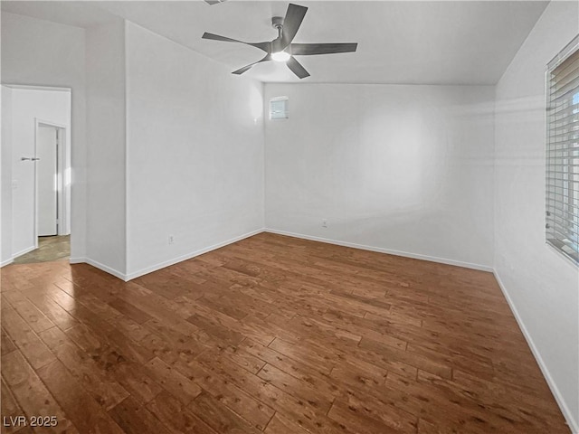 empty room featuring hardwood / wood-style floors, baseboards, and ceiling fan