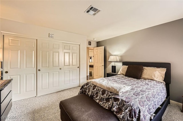 carpeted bedroom with baseboards, visible vents, and a closet