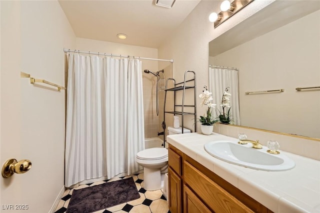 bathroom featuring tile patterned floors, toilet, vanity, and shower / tub combo with curtain