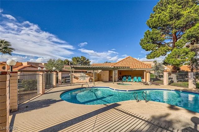 pool with a patio area and fence