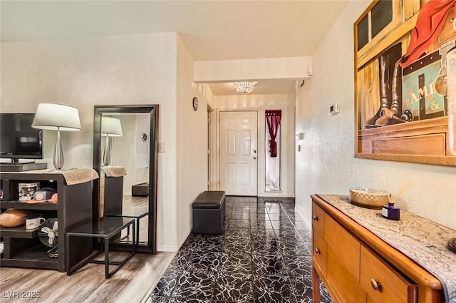 entrance foyer featuring an inviting chandelier and baseboards