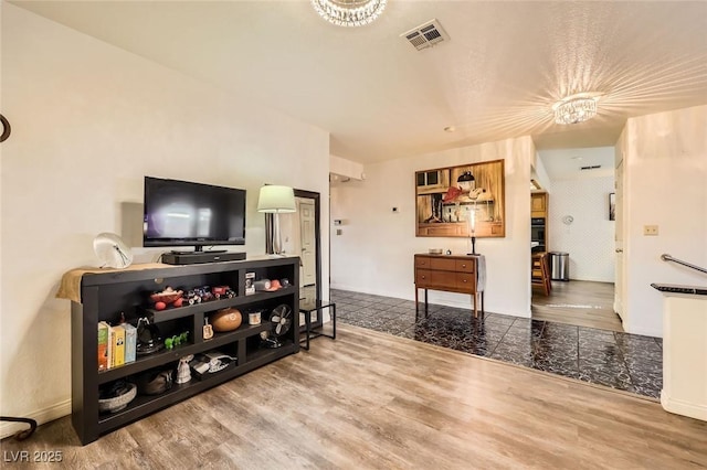 living room with visible vents and wood finished floors