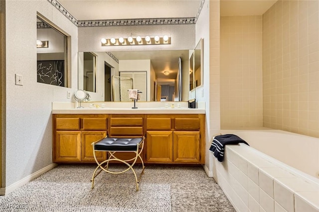 bathroom featuring double vanity, baseboards, a bath, and tile patterned flooring