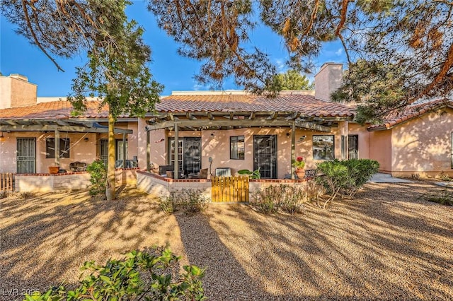 back of property featuring stucco siding, a patio, and a tile roof