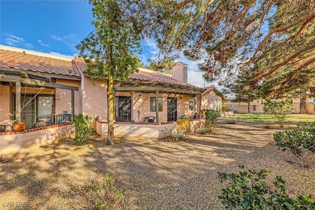2611 Laguna Shores Ln, Las Vegas, NV 89121 - back of house featuring stucco siding, a chimney, and a tiled roof