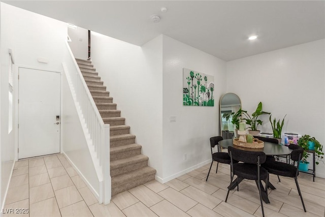 dining room featuring recessed lighting, stairs, and baseboards