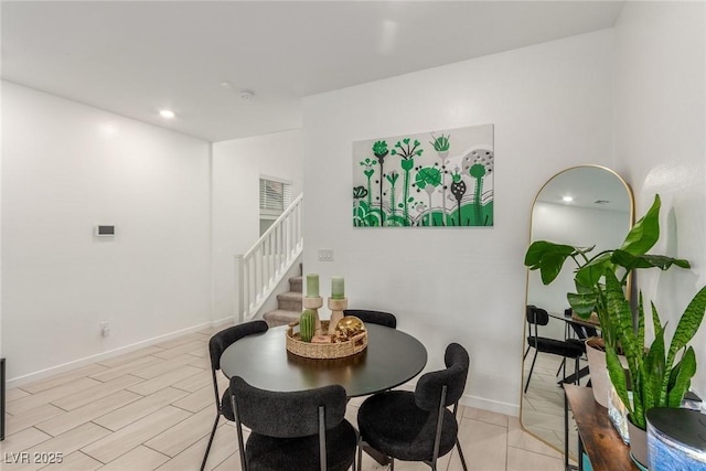 dining area featuring recessed lighting, light wood-type flooring, stairs, and baseboards