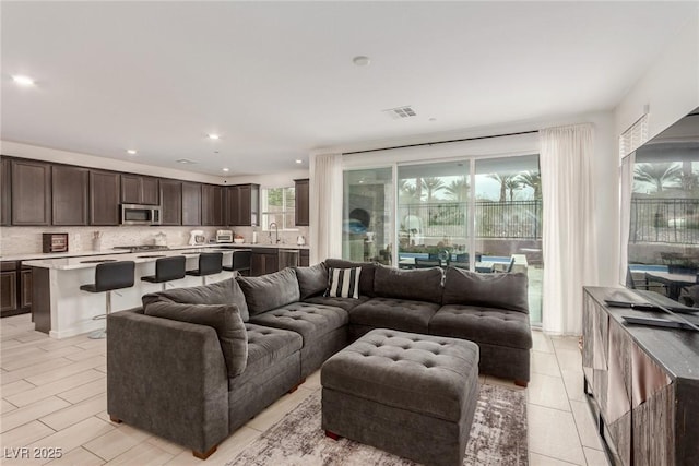 living area featuring recessed lighting and visible vents