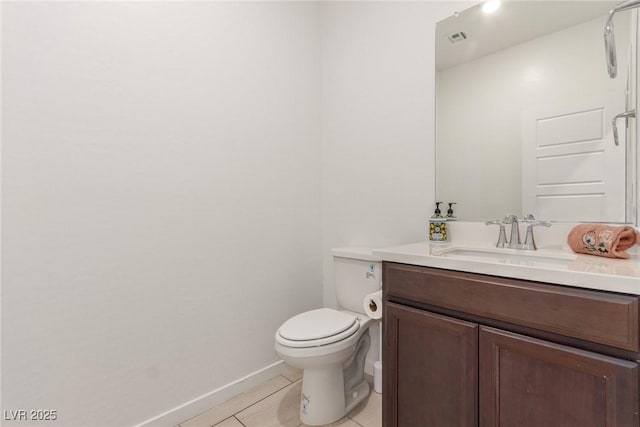 bathroom featuring vanity, baseboards, visible vents, tile patterned floors, and toilet