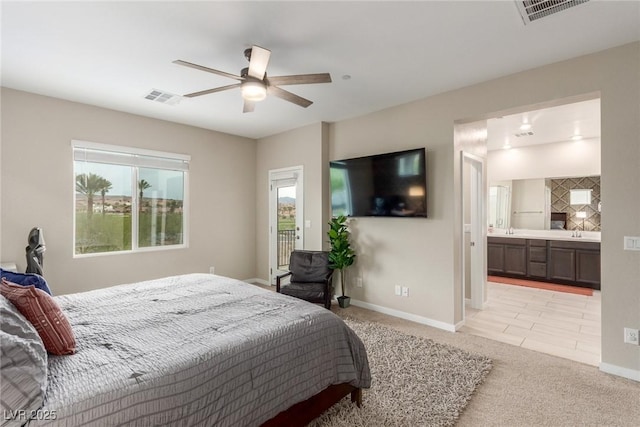 bedroom with visible vents, baseboards, and light colored carpet