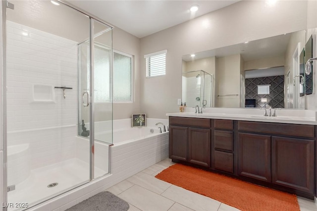 full bath with double vanity, a stall shower, a sink, and a bath