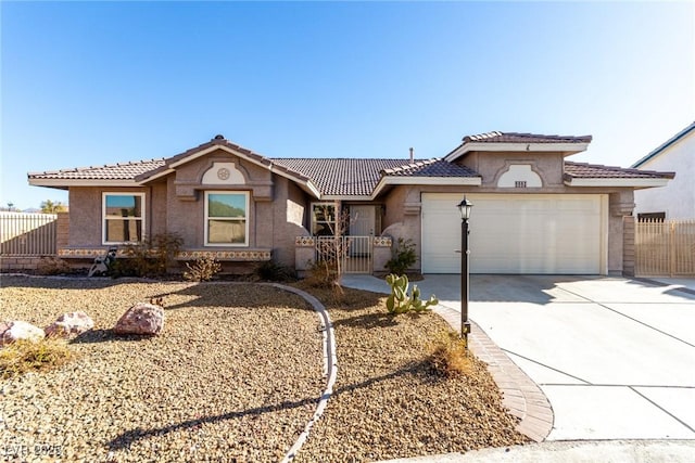 ranch-style house featuring driveway, fence, an attached garage, and a gate