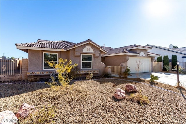 view of front of home with a tile roof, stucco siding, concrete driveway, and fence