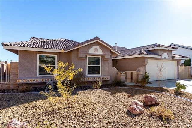 view of front of house featuring fence, a tile roof, concrete driveway, stucco siding, and a garage