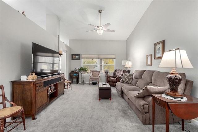 living area with light carpet, high vaulted ceiling, and ceiling fan