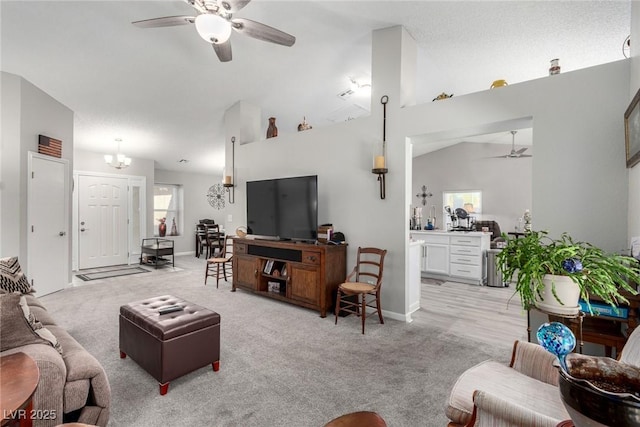 living room featuring light carpet, a ceiling fan, and vaulted ceiling