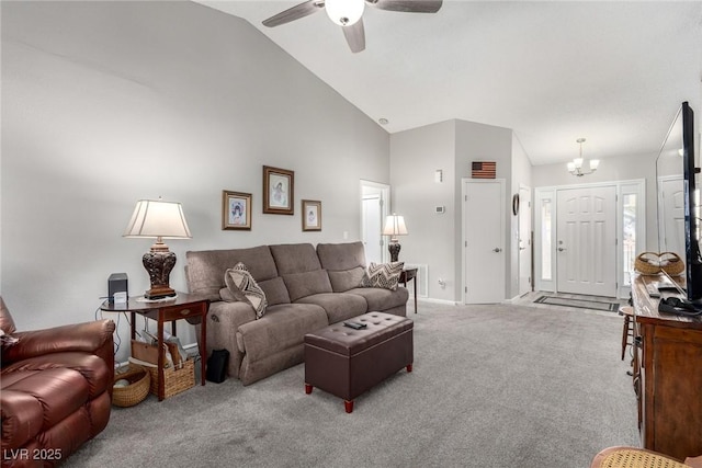 carpeted living room featuring high vaulted ceiling and ceiling fan with notable chandelier