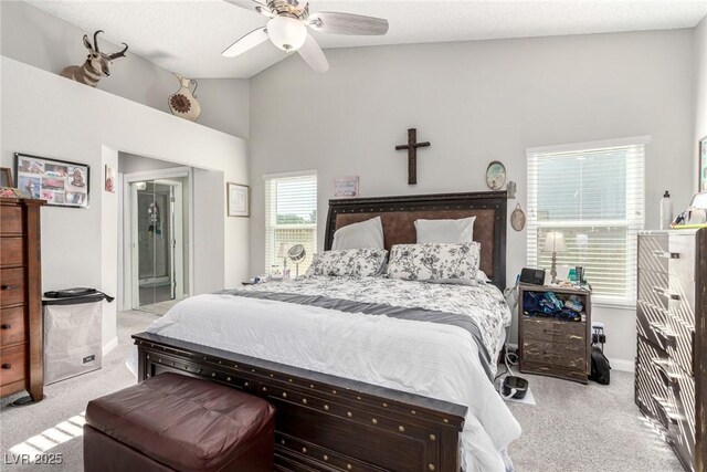 bedroom with ceiling fan, carpet flooring, and vaulted ceiling