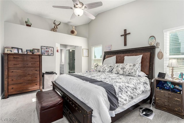 bedroom with ceiling fan, ensuite bathroom, lofted ceiling, and carpet floors