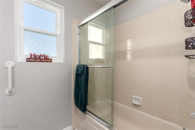 full bathroom with bath / shower combo with glass door