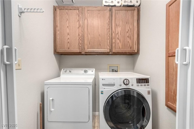 laundry room featuring washer and dryer and cabinet space