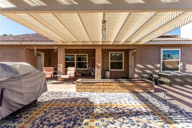 view of patio with a pergola and grilling area