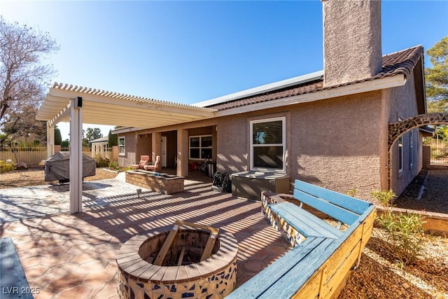 view of patio / terrace featuring fence, a pergola, and an outdoor fire pit