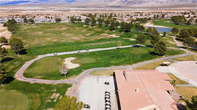 drone / aerial view with a mountain view and view of golf course