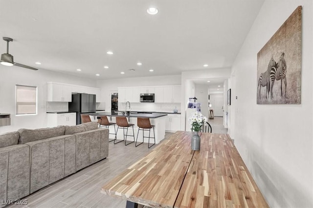 interior space featuring light wood finished floors, recessed lighting, and ceiling fan